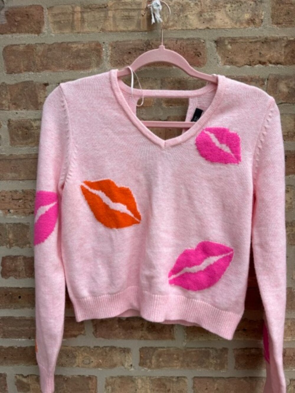 Witty Fox Brand sweater pink with lips and a beautiful opening on the back side.